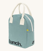 Fluf zip lunch bag in a light pastel blue colour with a white handle and lunch logo on the bottom with a white zip side detail on a cream background 