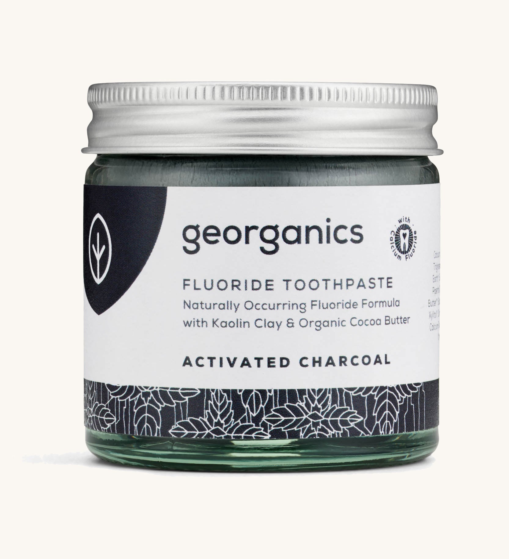 A jar of the Georganics activated fluoride toothpaste on a cream background