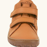 Front of the Froddo natural leather kids barefoot shoe in rusty brown showing the velcro straps and flexible sole. Shoe has a wide toe box and zero drop profile
