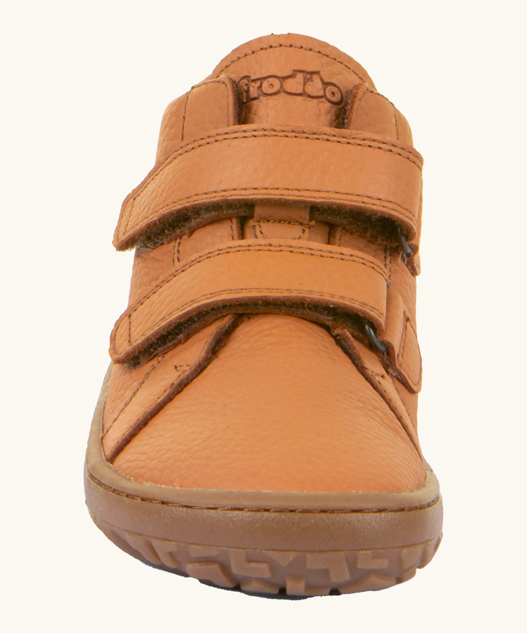 Front of the Froddo natural leather kids barefoot shoe in rusty brown showing the velcro straps and flexible sole. Shoe has a wide toe box and zero drop profile