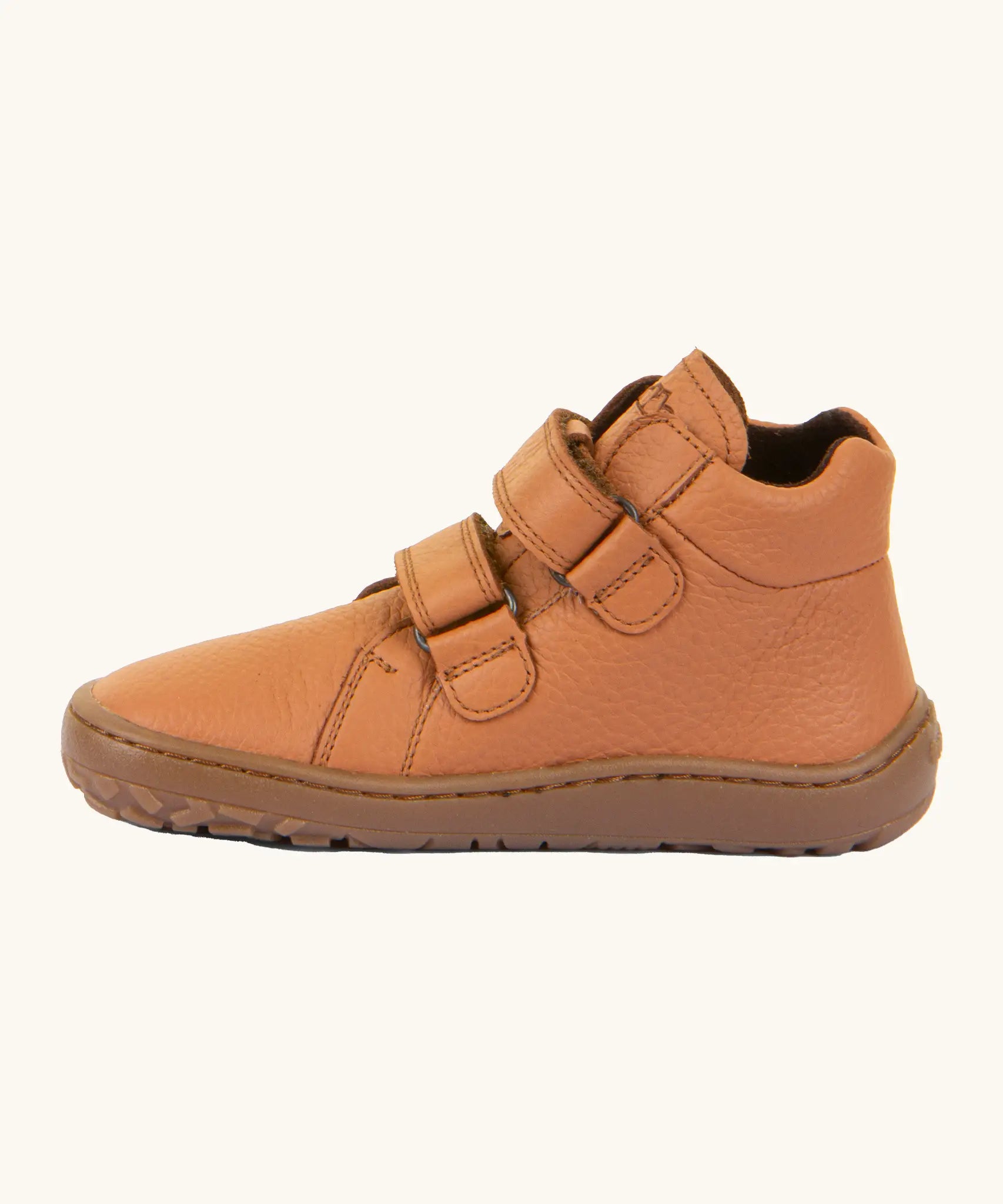 Side of Froddo natural leather kids barefoot shoe in rusty brown showing the padded ankle suppor and velcro straps looped through the eyelets