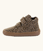 Side of Froddo natural leather kids barefoot shoe in leopard print showing the padded ankle support and velcro straps looped through the eyelets