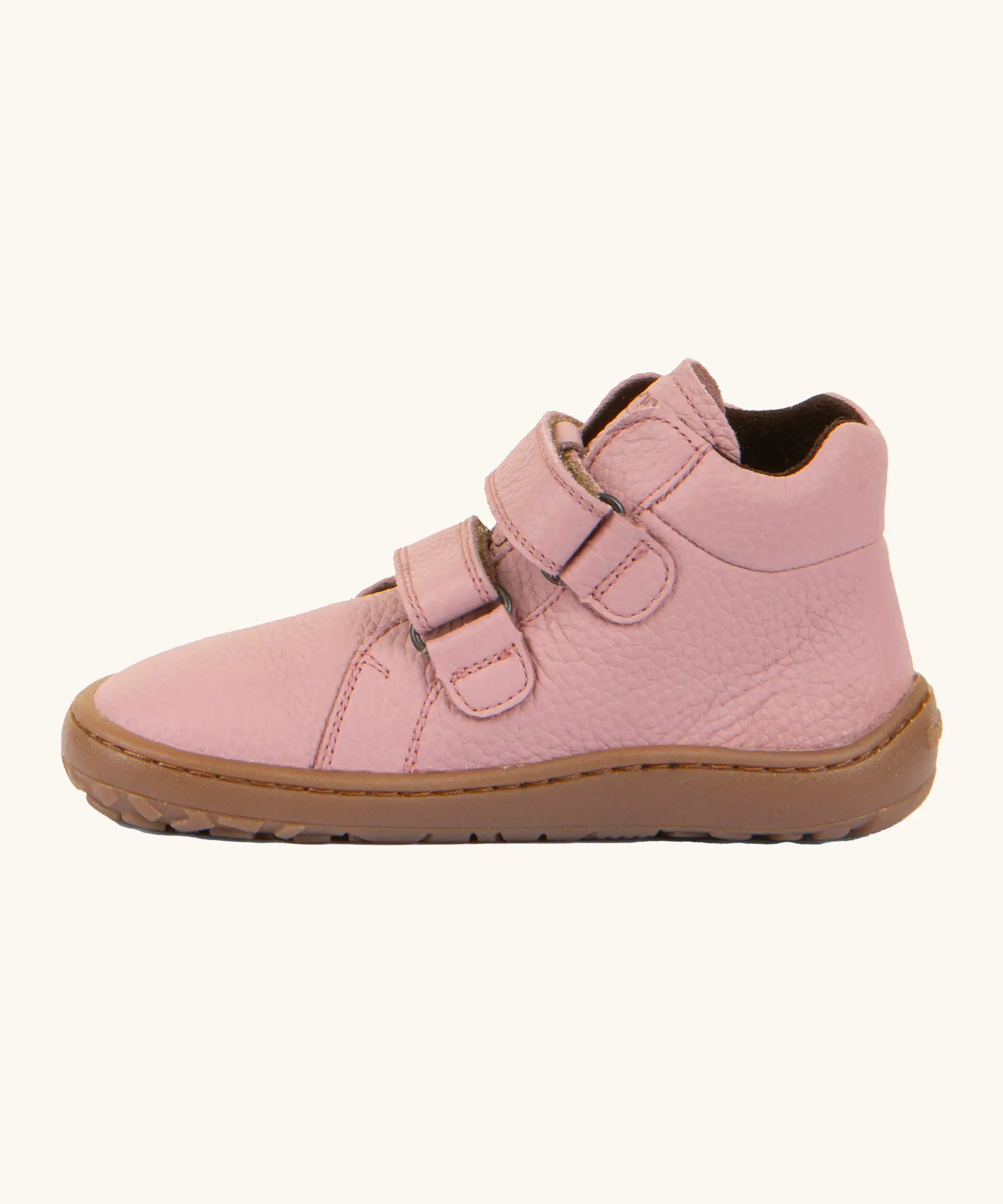Side of Froddo natural leather kids barefoot shoe in pink showing the padded ankle support and velcro straps looped through the eyelets