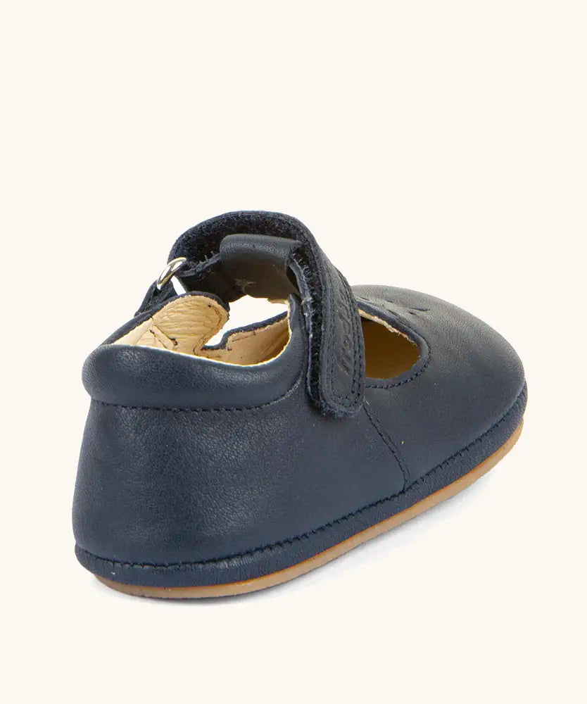 Back of Froddo barefoot pre walker baby shoe in dark blue. A natural leather shoe with a velcro t bar strap and padded ankle 