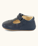 Side of Froddo barefoot pre walker baby shoe in dark blue. A natural leather shoe with a velcro t bar strap