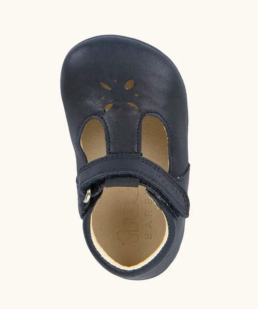 Froddo barefoot baby pre walker shoe in dark blue. A natural leather shoe with a velcro t bar strap and flower cut out on front