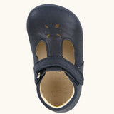 Froddo barefoot baby pre walker shoe in dark blue. A natural leather shoe with a velcro t bar strap and flower cut out on front