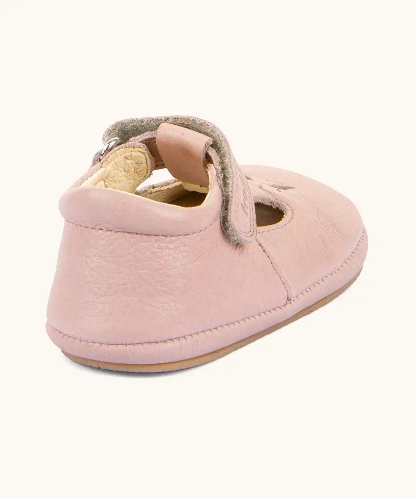 Back of Froddo barefoot walker baby shoe in pink. A natural leather shoe with a velcro t bar strap and padded ankle 