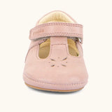 Front of Froddo barefoot walker baby shoe in pink. A natural leather shoe with a velcro t bar strap and flower cut out on toe