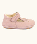 Side of Froddo barefoot walker baby shoe in pink. A natural leather shoe with a velcro t bar strap and rubber sole
