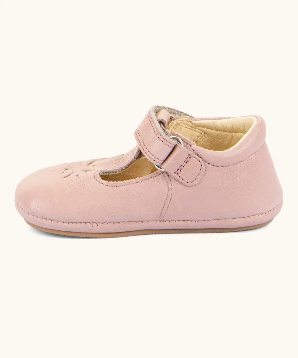 Side of Froddo barefoot walker baby shoe in pink. A natural leather shoe with a velcro t bar strap