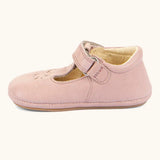 Side of Froddo barefoot walker baby shoe in pink. A natural leather shoe with a velcro t bar strap