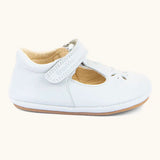 Side of Froddo barefoot pre walker baby shoe in white. A natural leather shoe with a velcro t bar strap and rubber sole