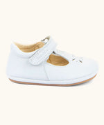 Side of Froddo barefoot pre walker baby shoe in white. A natural leather shoe with a velcro t bar strap and rubber sole