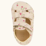 Top down view ofFroddo natural leather barefoot baby pre walker sandal shoe in pink with a repeating floral design, showing 2 front velcro straps 