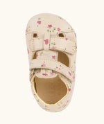 Top down view ofFroddo natural leather barefoot baby pre walker sandal shoe in pink with a repeating floral design, showing 2 front velcro straps 