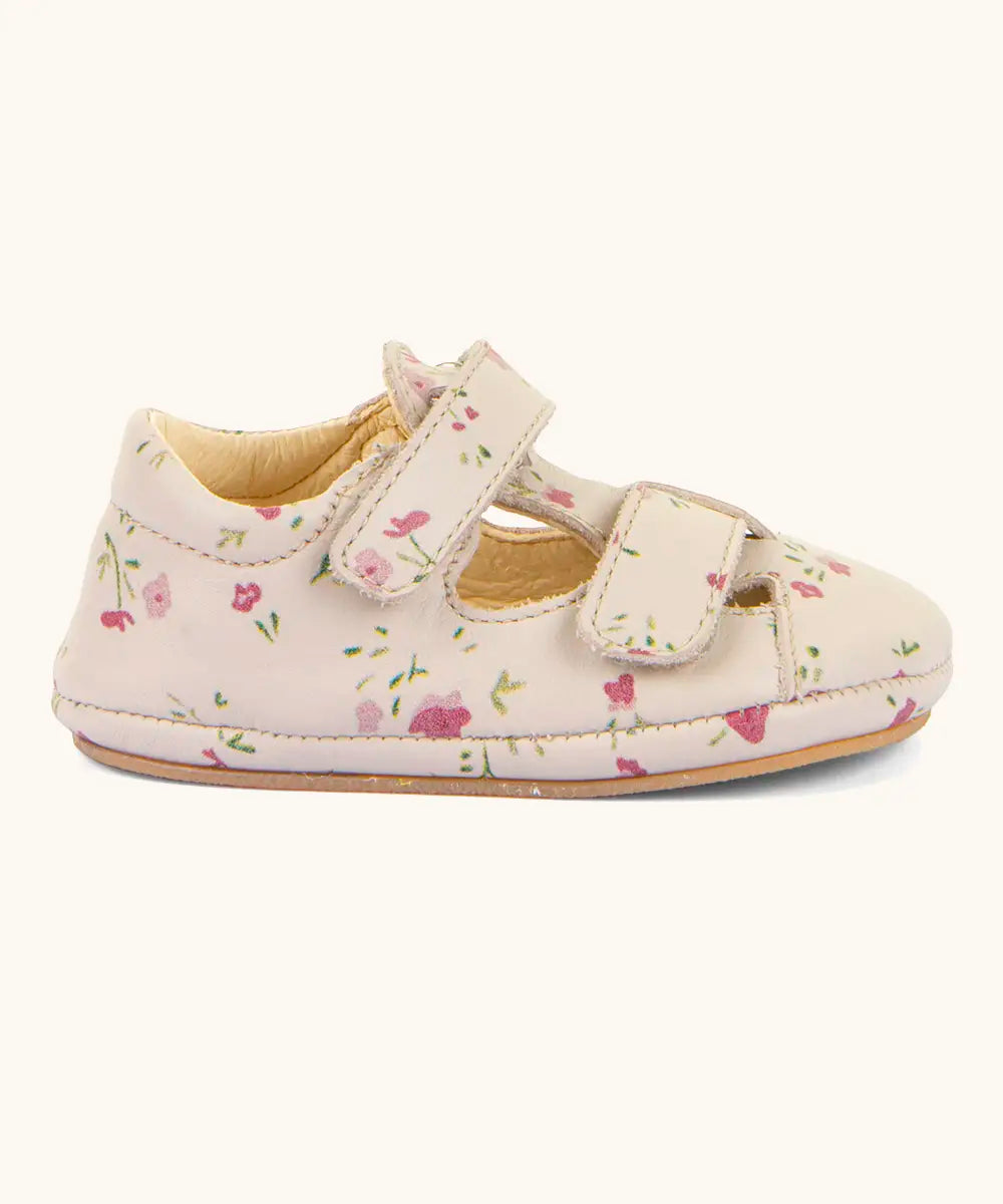Side of Froddo pink natural leather barefoot pre walker sandal shoe with a repeating floral patterns showing 2 front velcro straps 