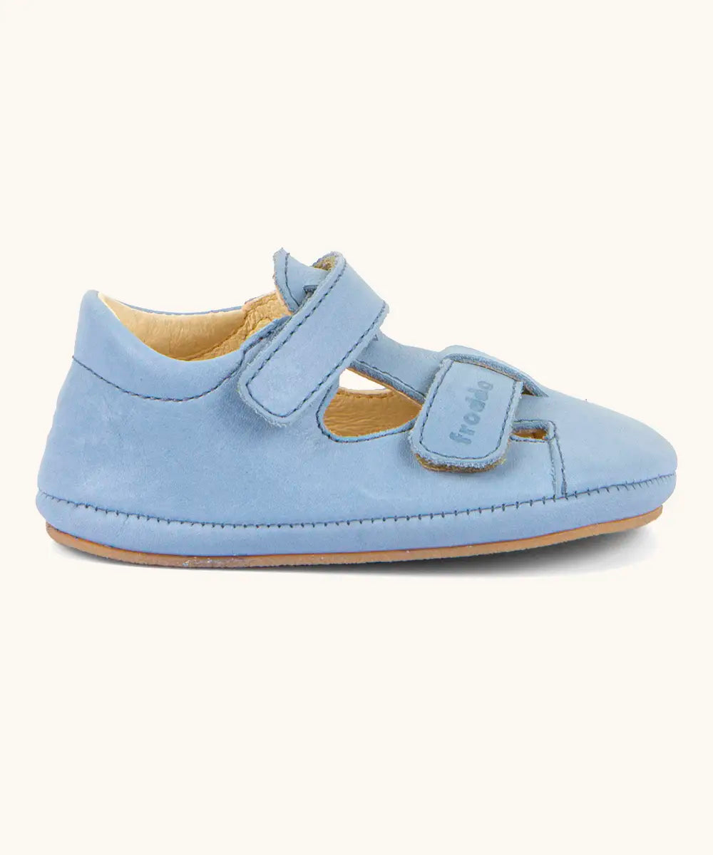 Side of Froddo natural leather barefoot baby pre walker sandal shoe in light blue showing 2 front velcro straps 