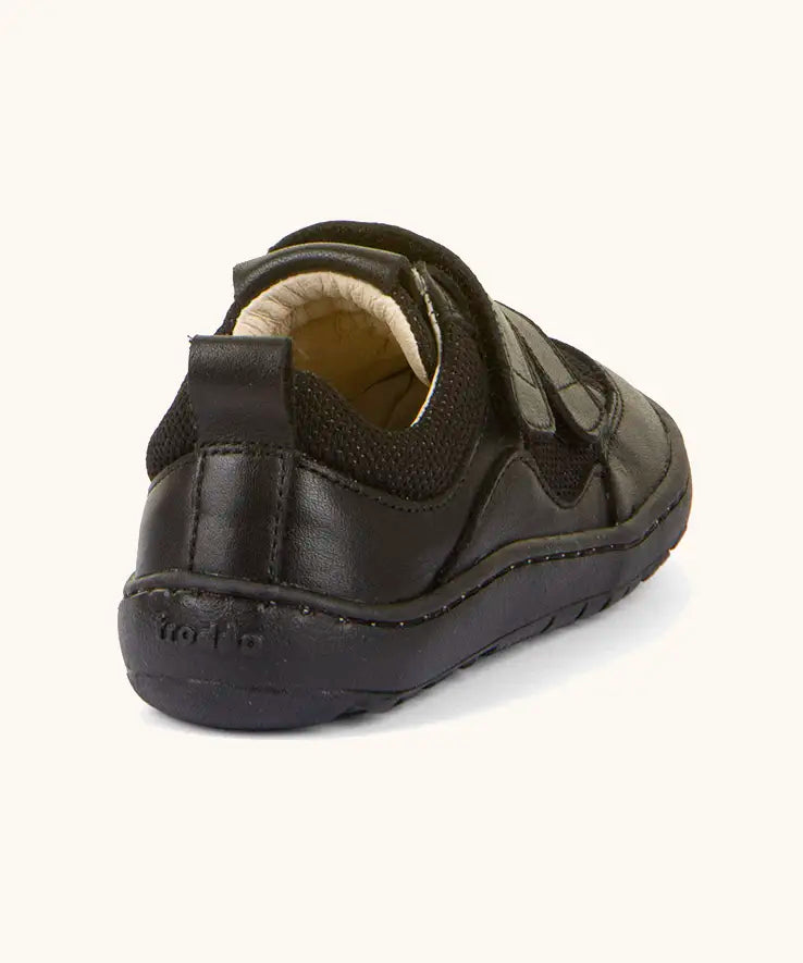Back of Froddo barefoot low profile children's shoe in black showing 2 padded ankle support and black grip sole