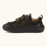 Side of Froddo barefoot low profile children's shoe in black showing 2 velcro fasteners looped through eyelets