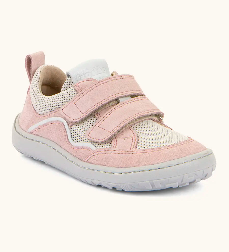 Froddo barefoot base children's shoe in pale pink with a white stripe. A trainer showing 2 velcro fasteners and rubber sole
