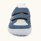 Front of the Froddo barefoot base children's shoe in blue and white showing the 2 blue velcro fasteners and a grey grippy sole
