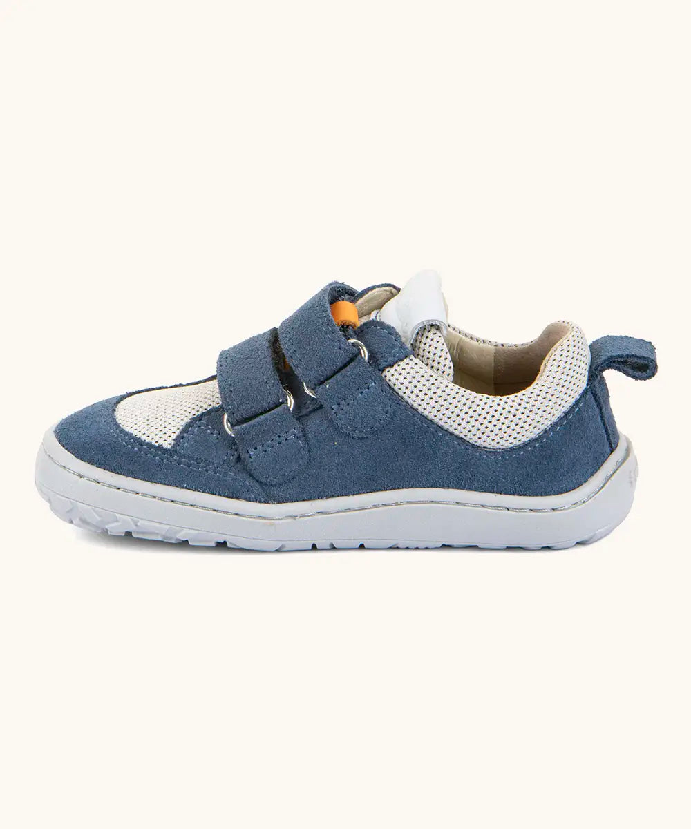 Side of Froddo barefoot low profile children's shoe in blue and white showing 2 blue velcro fasteners looped through eyelets