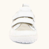 Front of the Froddo barefoot base children's shoe in white showing the 2 velcro fasteners and a white grippy sole