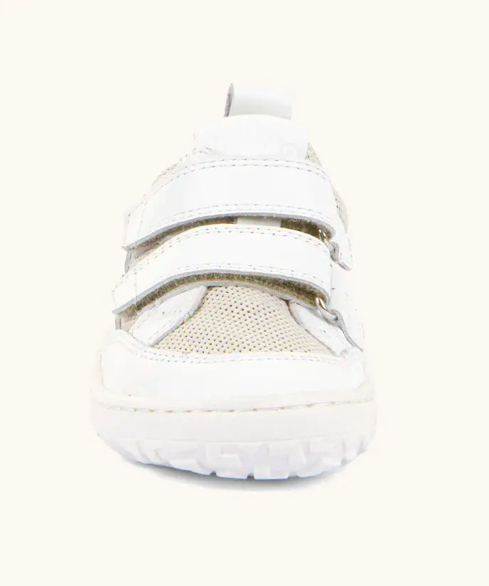 Front of the Froddo barefoot base children's shoe in white showing the 2 velcro fasteners and a white grippy sole