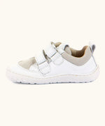 Side of Froddo barefoot low profile children's shoe in white showing 2 velcro fasteners looped through eyelets