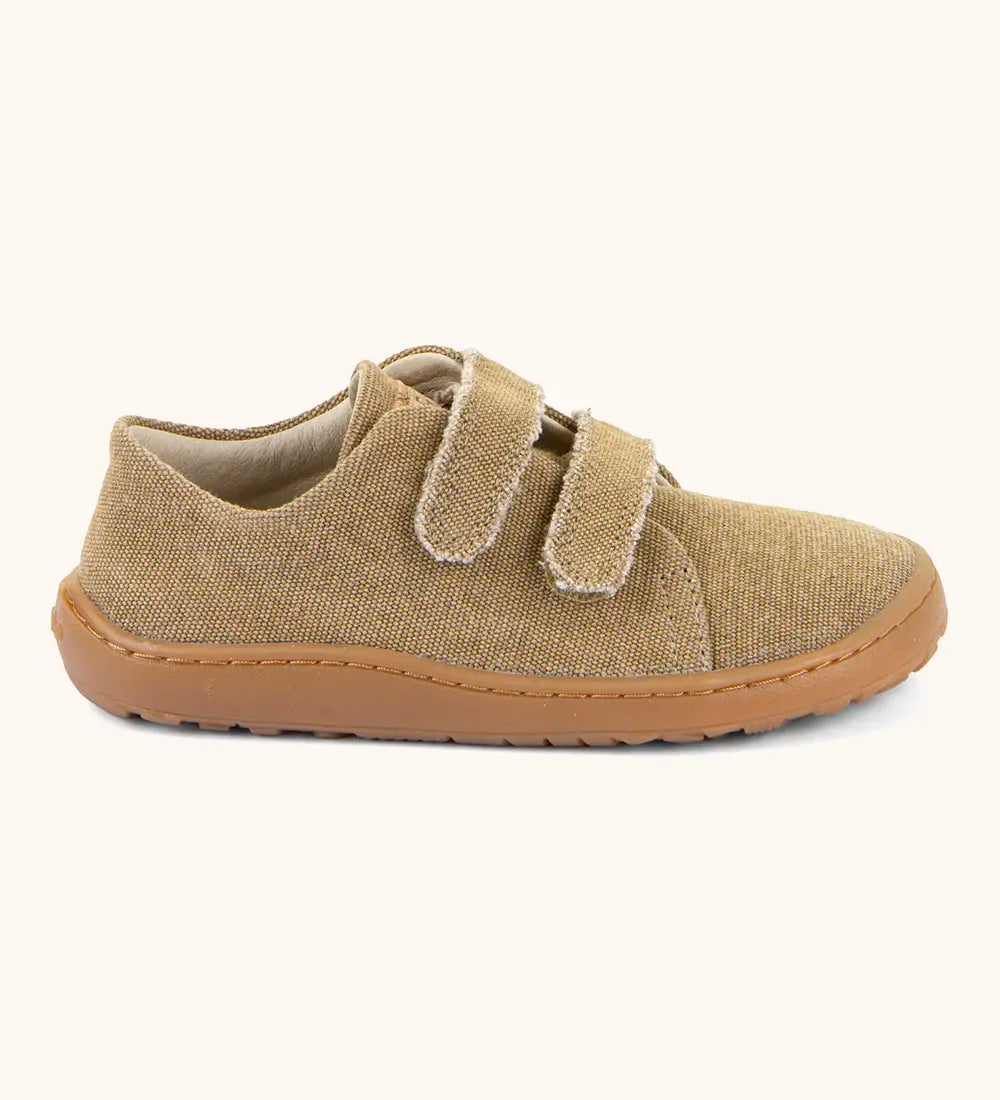 Side of Froddo barefoot botaniq kids canvas stye shoes in beige shows velcro straps a brown grippy sole