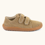 Side of Froddo barefoot botaniq kids canvas stye shoes in beige shows velcro straps a brown grippy sole