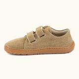 Froddo barefoot botaniq kids canvas stye shoes in beige shows velcro straps looped through the eyelets and a brown grippy sole