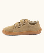 Froddo barefoot botaniq kids canvas stye shoes in beige shows velcro straps looped through the eyelets and a brown grippy sole