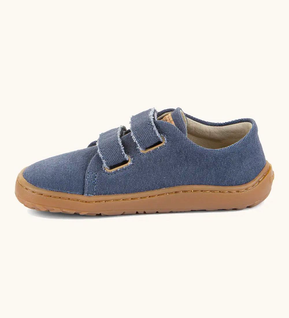 Froddo barefoot botaniq kids canvas stye shoes in blue shows velcro straps looped through the eyelets and a brown grippy sole