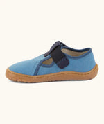 Side of Froddo barefoot canvas style kids shoes in light blue showing t-bar velcro fastener lopped through the eyelet 