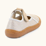 Back of Froddo barefoot canvas style kids shoes in pale cream with a t-bar velcro fastener and brown rubber sole