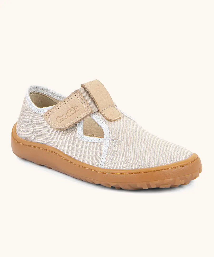 Froddo barefoot canvas style kids shoes in pale cream with a t-bar velcro fastener and brown rubber sole
