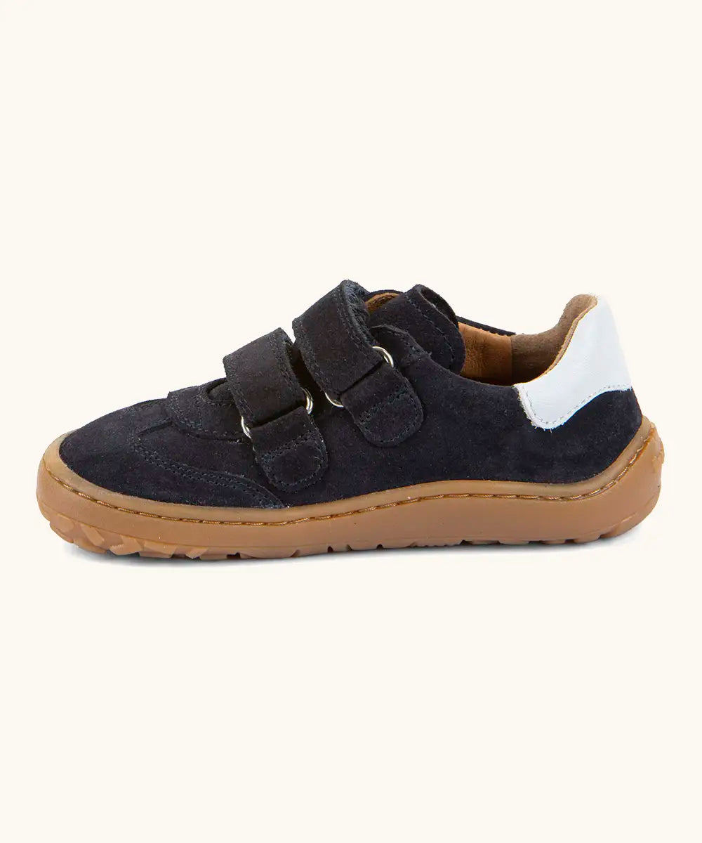 Side of Froddo barefoot f-motion kids shoes in dark blue showing 2 velcro fasteners looped through the eyelets