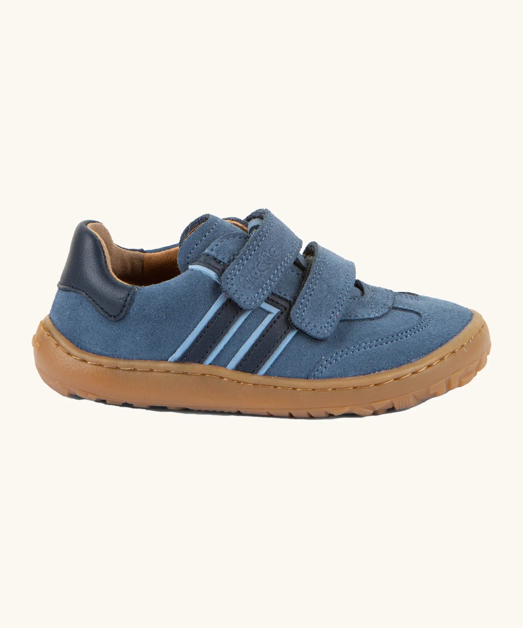 Side of Froddo's barefoot f-motion kids suede shoes in denim blue with contrasting dark side stripes, 2 velcro fasteners, flexible rubber sole. Trainer has a zero heel drop