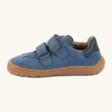 Side of Froddo's barefoot f-motion kids suede shoes in denim blue showing the velcro fasteners looped through the eyelets 