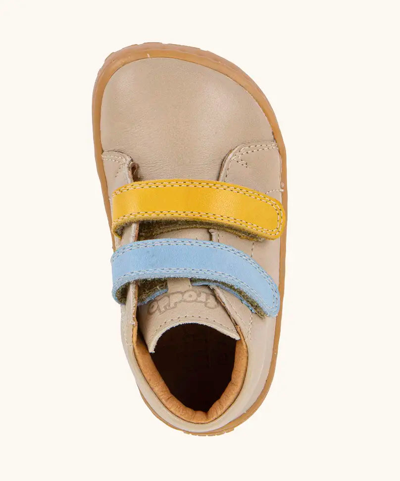 Top view of Froddo barefoot first step baby shoe in dark blue showing the blue and yellow velcro and inner sole detail