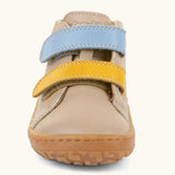 Front of the Froddo barefoot first step baby shoe in beige showing the 2 velcro fastener in blue and yellow
