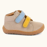 Side of the Froddo barefoot first step baby shoe in dark blue a showing 2 velcro fasteners in blue and yellow