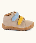Side of the Froddo barefoot first step baby shoe in dark blue a showing 2 velcro fasteners in blue and yellow