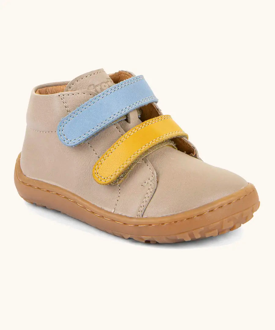 Froddo barefoot first step baby shoe in beige. A natural leather shoe with a blue and yellow velcro and grippy sole