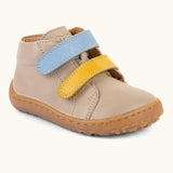 Froddo barefoot first step baby shoe in beige. A natural leather shoe with a blue and yellow velcro and grippy sole