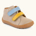 Froddo barefoot first step baby shoe in beige. A natural leather shoe with a blue and yellow velcro and grippy sole