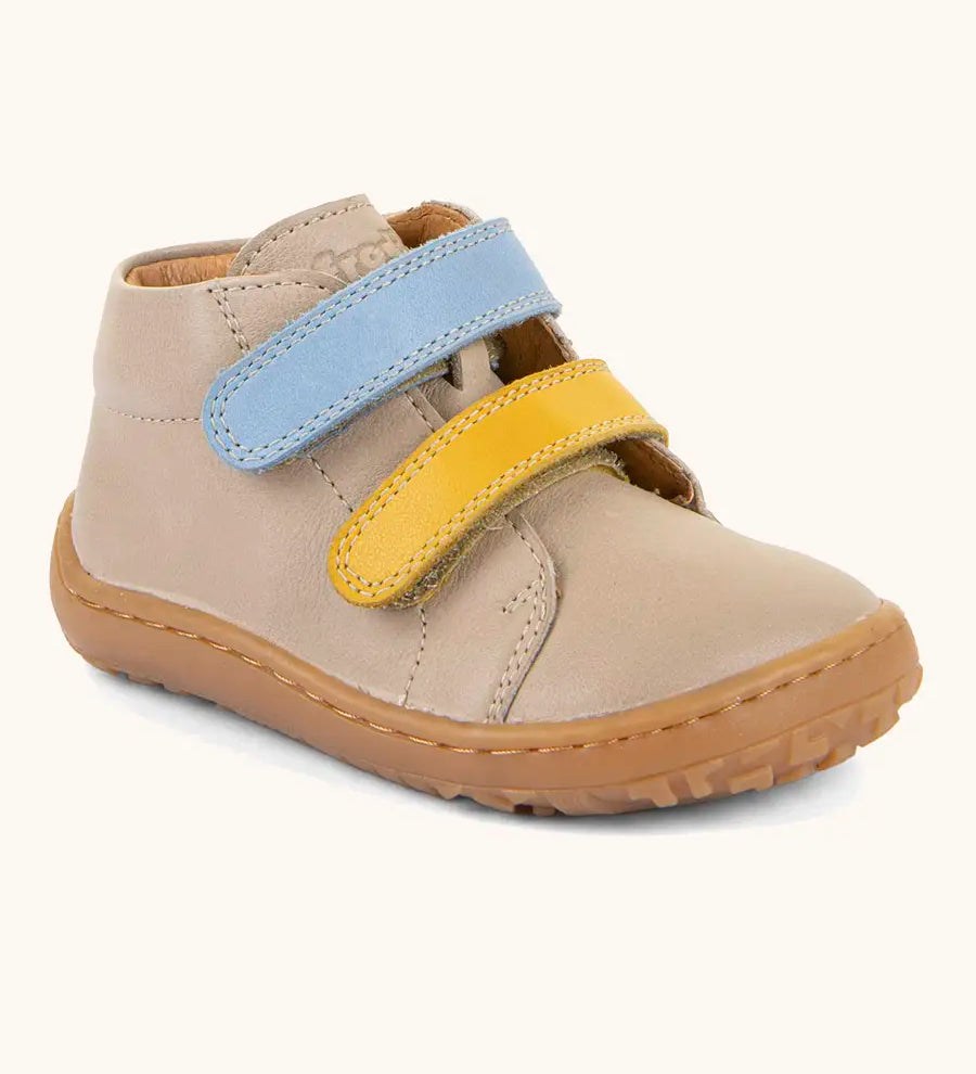 Froddo barefoot first step baby shoe in beige. A natural leather shoe with a blue and yellow velcro and grippy sole