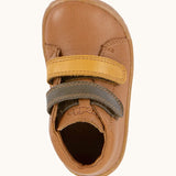 Top view of Froddo's light brown natural leather barefoot first step kids shoes showing the olive and mustard straps. Boot has a wide toe box shape